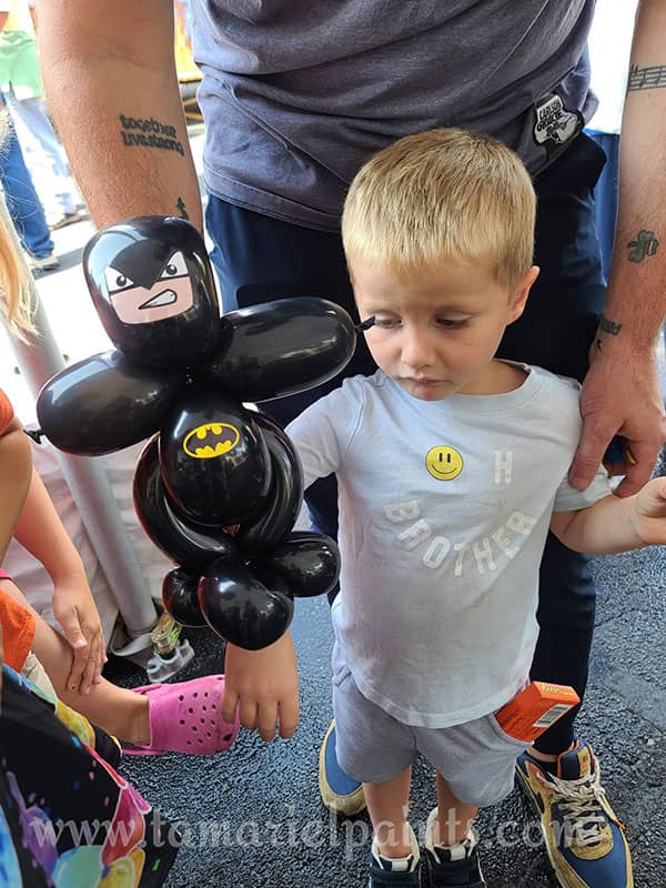 A child holds a twisted balloon Batman