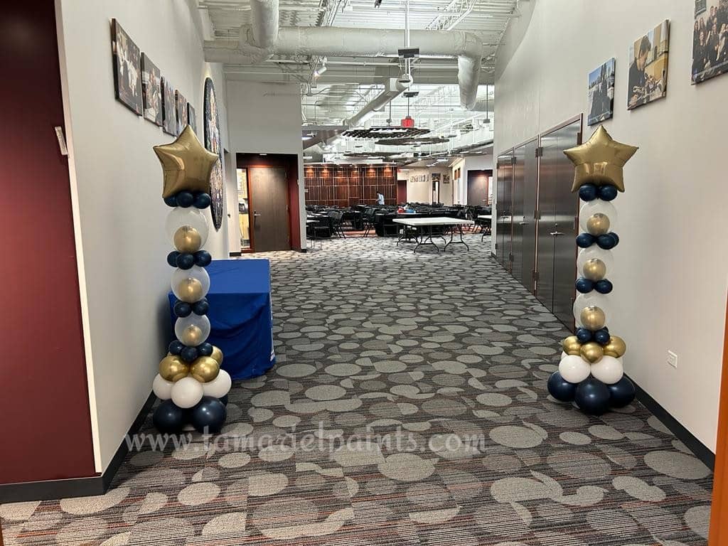 Decorative balloon display with gold stars on top