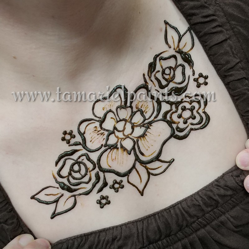 An intricate floral henna chest tattoo