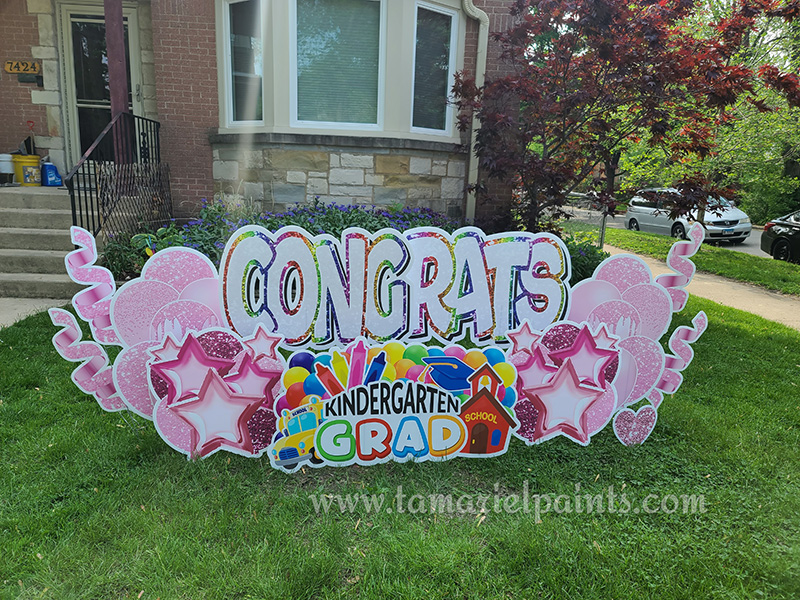 A photo of a custom made yard sign which reads Congrats Kindergarten Grad